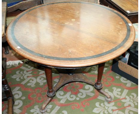 A continental oak centre table, 19th century, the circular moulded top with ebonised crossbanding on turned, tapering support