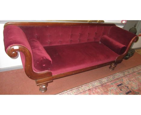 A mid 19th century mahogany sofa, with shaped arms and buttoned back.