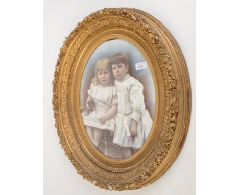 A gilt carved picture frame, 19th century, with a print of two young girls, 59 x 49cm. 