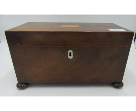 A George III mahogany tea caddy with two compartments flanking a central glass bowl, on bun feet, height 16.8cm, width 30cm, 