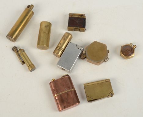 A copper trench art lighter with brass detailing, together with nine other trench art lighters.