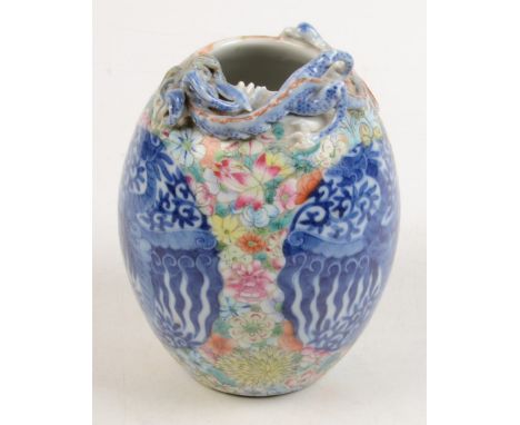 A Chinese ovoid vase with dragon in high relief around the mouth, the body decorated with two oval blue and white panels port