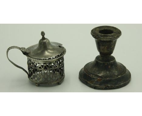 A filled silver low candlestick and a pierced silver mustard pot.