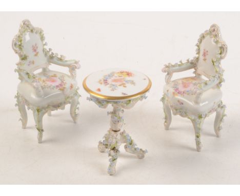 A Dresden style porcelain tripod table, with floral enamelled decoration and gilding together with a pair of matching open ar