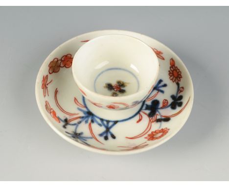 An 18th century English porcelain miniature tea bowl and saucer, decorated with an Imari pattern painted in underglaze blue e