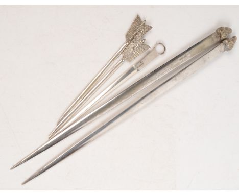 A pair of large meat skewers with ram's heads finials, together with a pair of small arrow skewers and one other skewer.