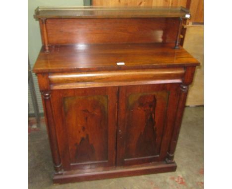 A Victorian rosewood chiffionier, the upper shelf with a pierced brass gallery above a single frieze drawer and a pair of pan