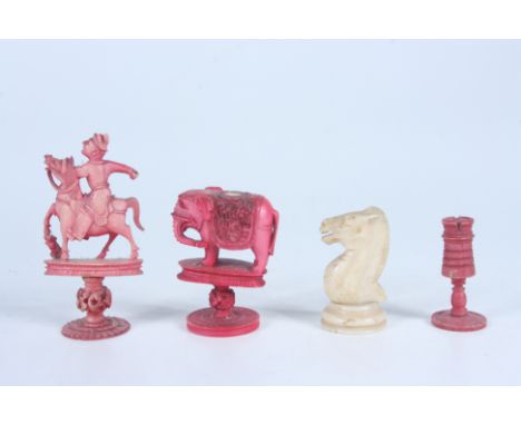 Three Indian red stained ivory chess pieces, circa 1900, heights 8cm, 5.5cm and 4.3cm and an ivory knight, 19th century, heig