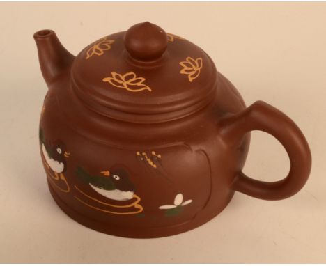 A Chinese Yixing teapot, the body decorated with ducks and calligraphy, seal mark to base, height 9cm, width 15cm.