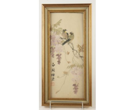 A Chinese painting on silk, early 20th century, with a pair of birds perched on a flowering branch, calligraphy and red seal 