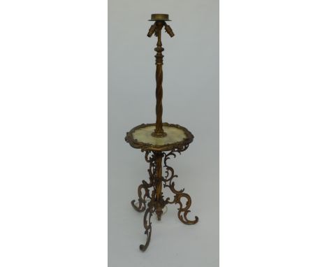 A gilt metal standard lamp, 20th century, with onyx shelf and curvilinear supports, height 148cm, diameter of shelf 46cm. 