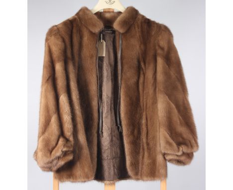 A light brown mink coat with leather neck tie, label inscribed 'R Danzig & Sons, London', length 67cm, size 10/12. Condition 