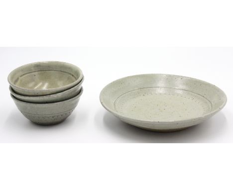 Four celadon glazed stoneware bowls, each with simple roulette decoration, unmarked.From the Bret Guthrie CollectionOriginall