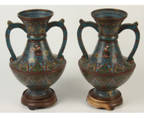A pair of Chinese cloisonne twin handled vases, 19th century, seal mark to base, height 31cm,