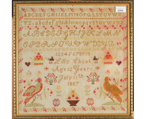 A needlework sampler by Lilly Choak, aged 12 years, July 11th 1887 depicting alphabet, numbers, birds, bowls of fruit and flo