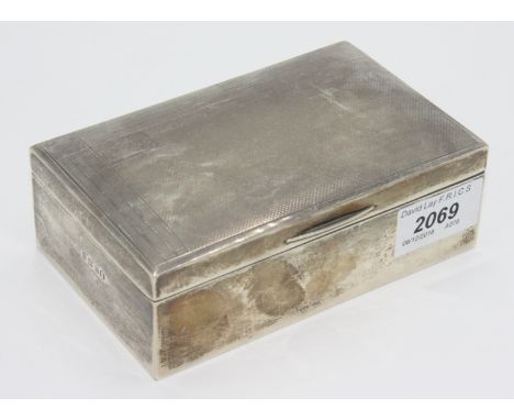 An engine turned silver cigarette box.