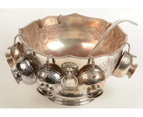 A punch set, the large bowl with lion mask handle, eight cups and a ladle.