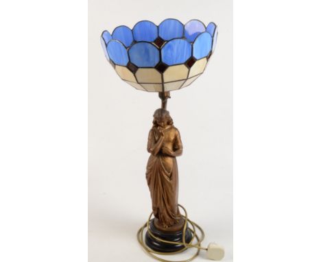 A gilt metal table lamp in the form of a lady with Tiffany style glass shade, height 64cm, diameter of shade 30cm. 