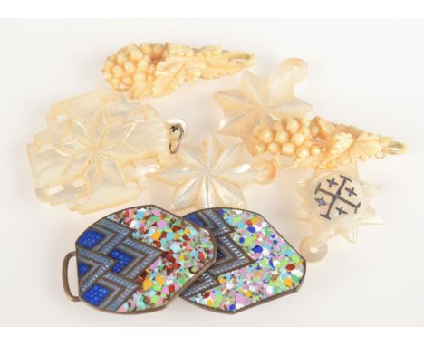 An enamel buckle, mother of pearl pendants and a pair of carved ivory pendants.