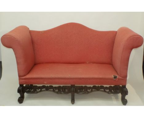 A magnificent sofa upholstered in coral damask in William and Mary style, the high scrolling arms and serpentine shaped crest