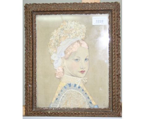 An early 20th century framed fabric portrait of a girl, 24 x 19cm.