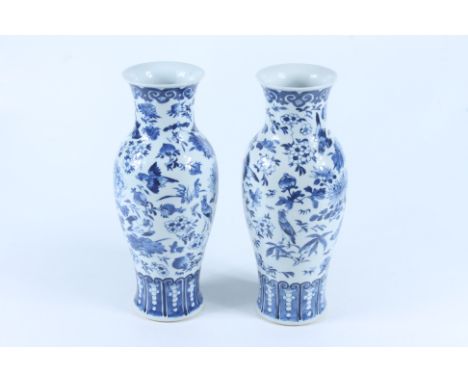 A pair of Chinese porcelain vases, late 19th century, each decorated with birds amongst foliage, kangxi four character marks 