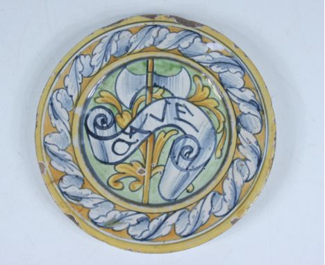 A majolica small plate, the centre decorated with a crossed inscribed banner ad axe, diameter 16cm.