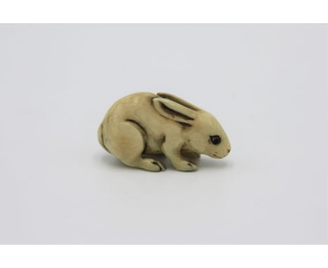 A ivory netsuke carved as a rabbit, early 20th century, height 1.9cm, width 3.4cm.