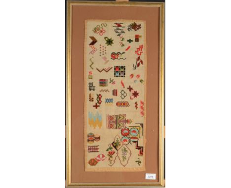 An unusual needlework sampler decorated with colourful geometric motifs and foliage, size of panel 57 x 23.5cm.