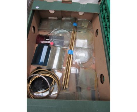 A box containing various oil lamp aspects to include clear, red, bull's-eye, etc
