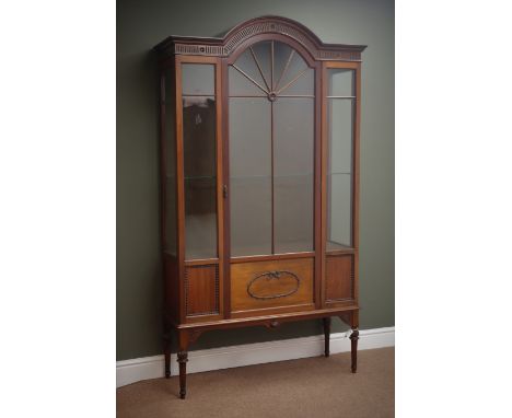 Edwardian mahogany display cabinet, stepped arch top with fluted frieze carved with flower heads, astragal glazed and panelle