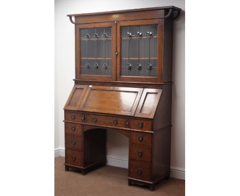 Edwardian oak bureau bookcase, two lead glazed doors enclosing shelves, sloped fall front with hinged flaps either side, well