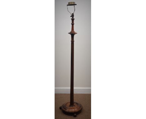 Early 20th century walnut standard lamp, turned and fluted column, circular platform base with three out splayed globular fee