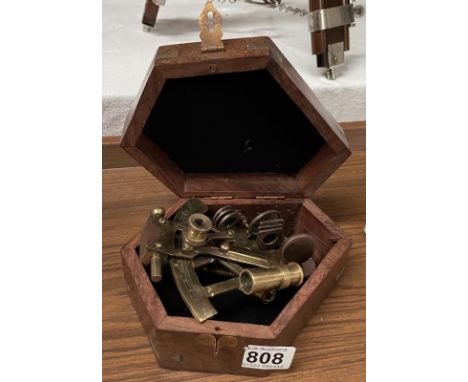 A mini sextant in hard wood case