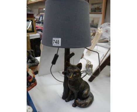 A table lamp featuring a figure of a fox. COLLECT ONLY