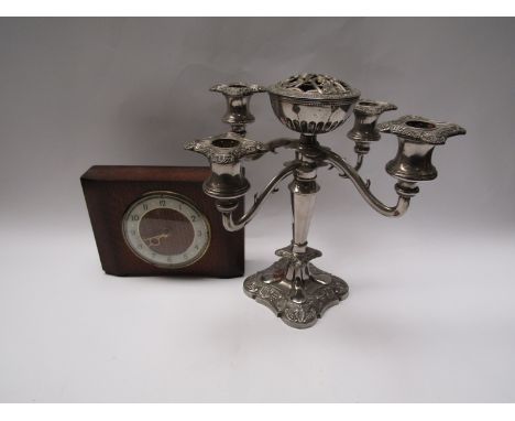 An oak mantel clock and silverplate four-sconce candlestick (2)