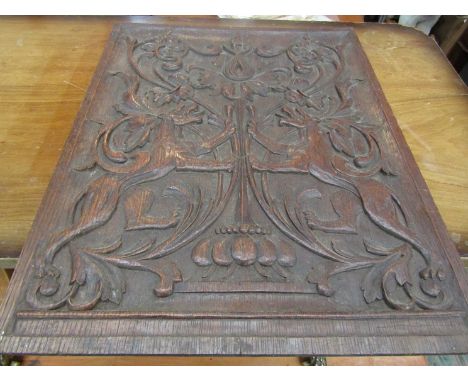A carved wooden panel with animal design, 46cm x 36cm 