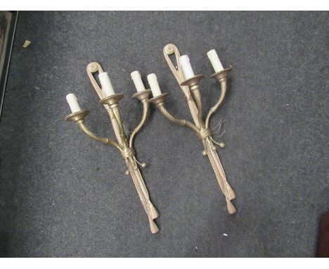 A pair of gilt three arm candlestick wall sconces, 60cm high each