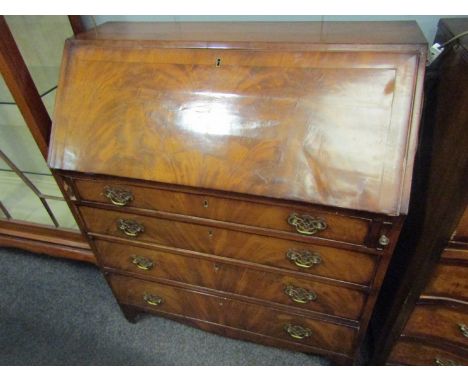 An early 19th Century flame mahogany bureau, the fall front with fitted interior over four long drawers, bracket supports, 10