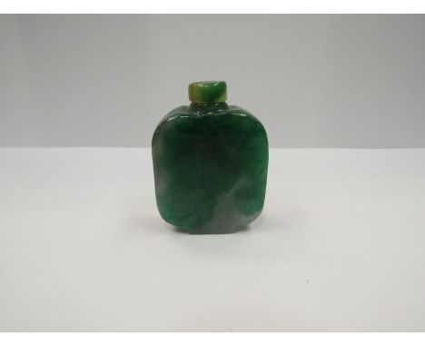 A jade snuff bottle with stopper