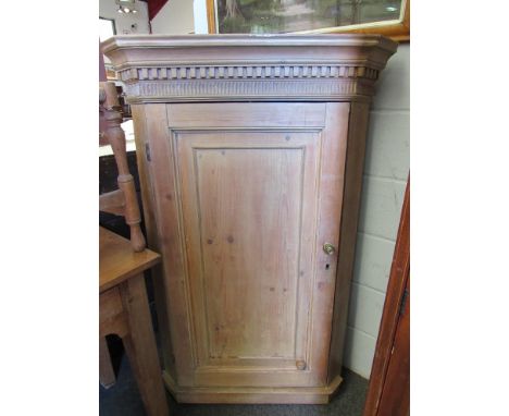 A 19th Century pine wall hanging corner cabinet with dentil moulded top, panel door, 134cm high x 87cm wide x 50cm deep