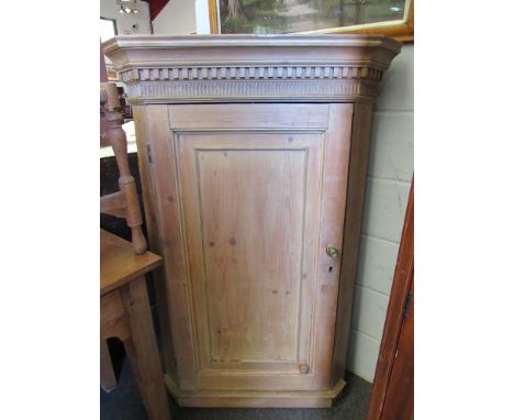 A 19th Century pine wall hanging corner cabinet with dentil moulded top, panel door, 134cm high x 87cm wide x 50cm deep