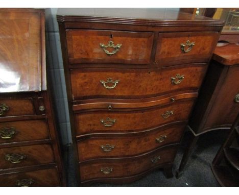 A reproduction walnut serpentine chest of two over four long drawers, bracket supports a/f, 109cm x 69cm x 46cm