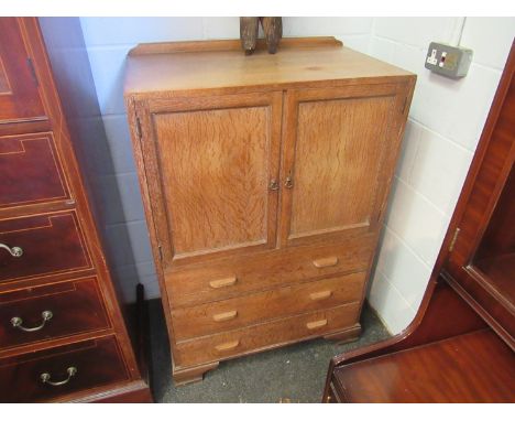 A Heals style limed oak tallboy, two doors over three drawers on bracket feet, 115cm x 76cm x 45cm 
