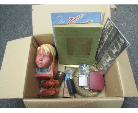 A box of lighters, stamps, a travel iron and a West German ceramic face mask, etc