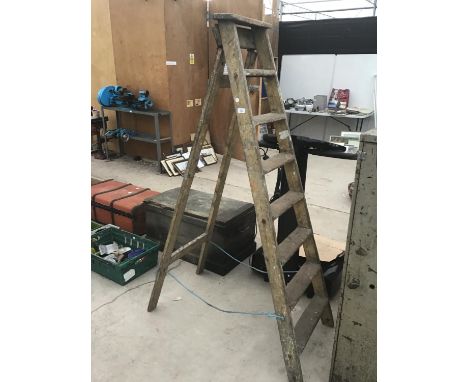 A PAIR OF VINTAGE EIGHT STEP WOODEN LADDERS 