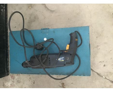 A METAL CASE WITH A ROTARY HAMMER DRILL IN WORKING ORDER 
