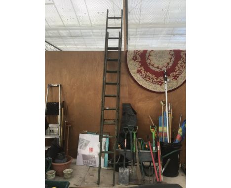 A VINTAGE WOODEN TWENTY RUNG TWO SECTION LADDER 