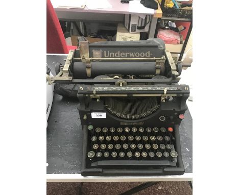 A VINTAGE UNDERWOOD TYPE WRITER WITH COVER 
