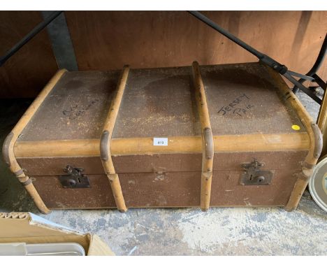A VINTAGE CANVAS AND WOODEN BOUND TRUNK 